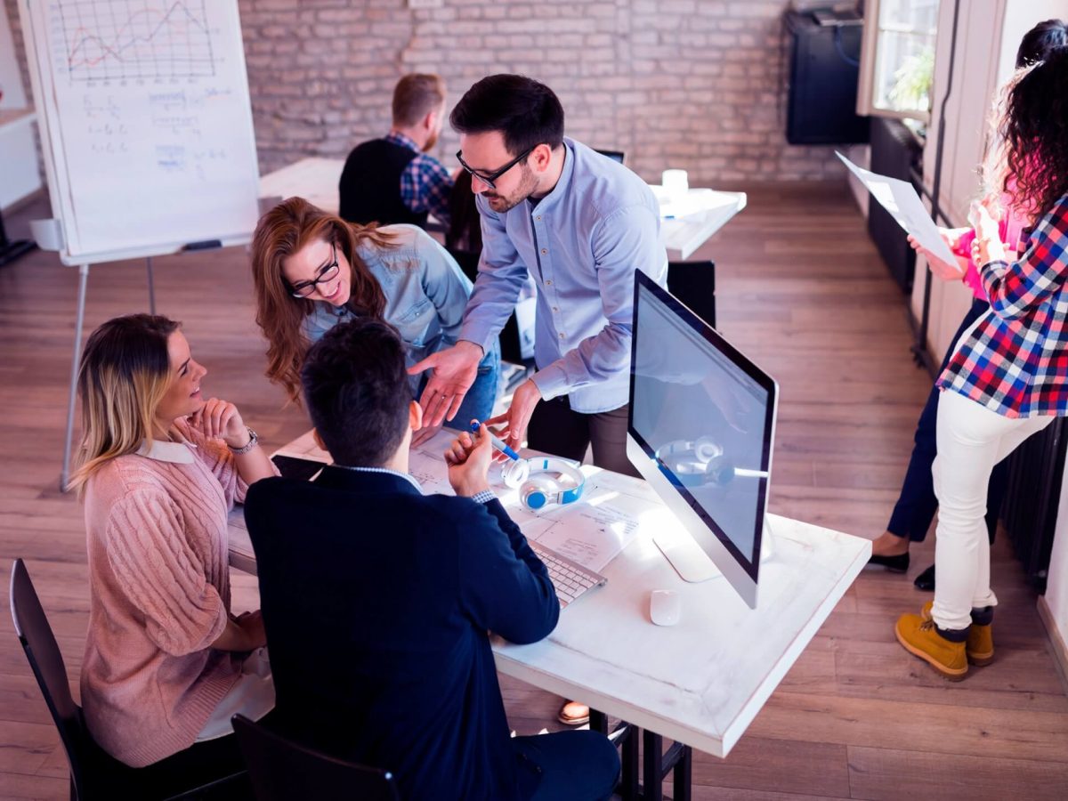 picture-of-young-architects-discussing-in-office-UGKJXLQ-scaled.jpg